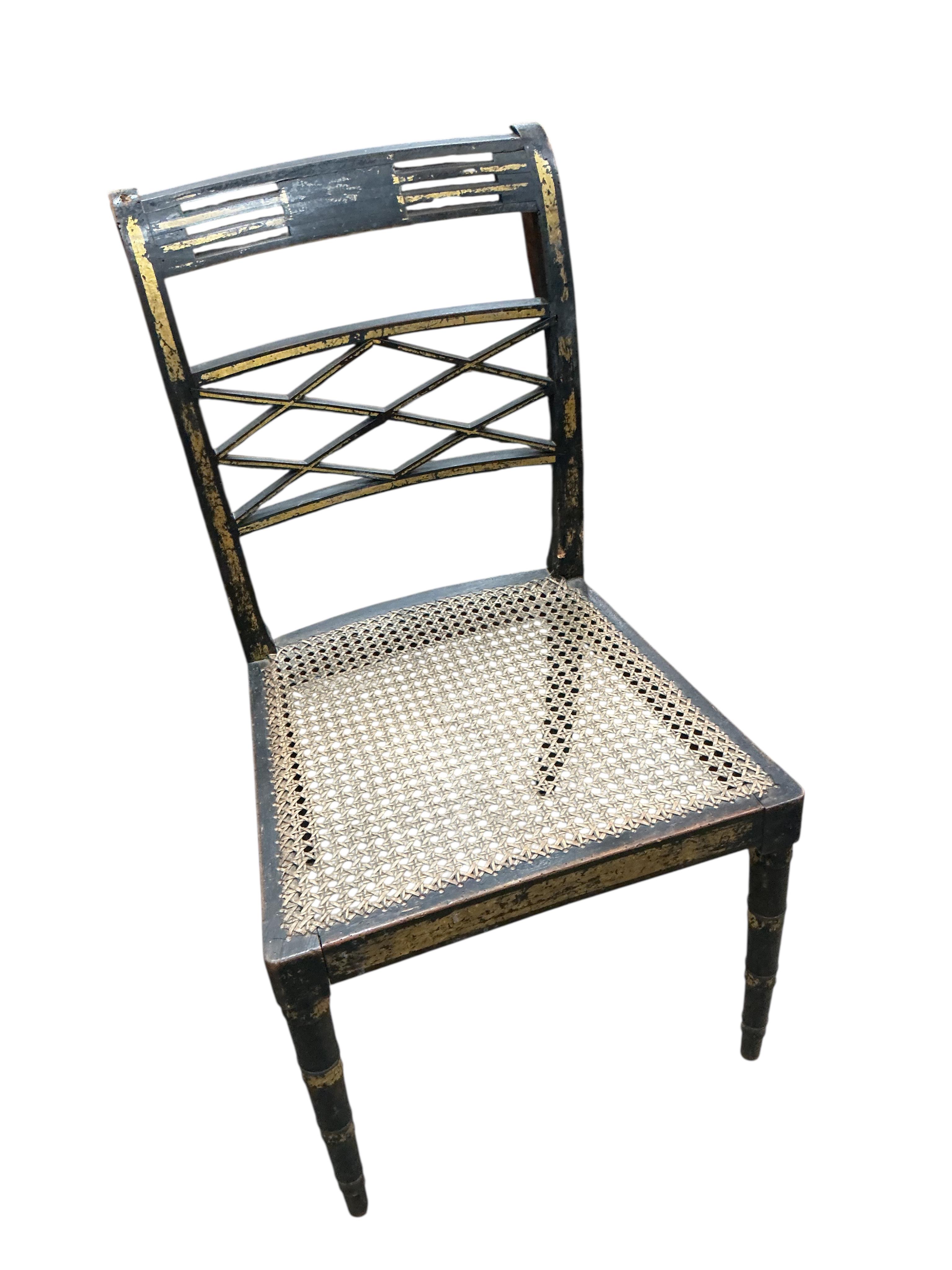 A set of four Regency ebonised cane seat dining chairs, width 46cm, depth 42cm, height 86cm